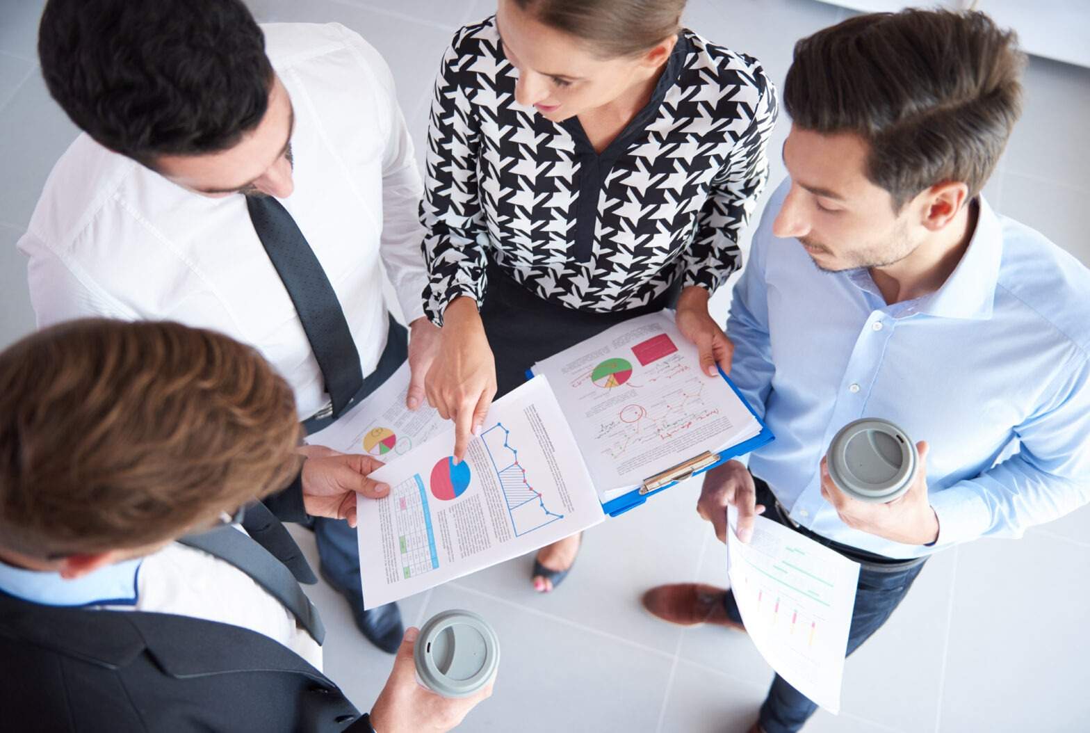 Four businessmen analyzing some documents